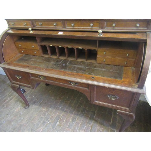 1752B - Early 20th Century oak roll top desk, the cylinder action top with a four drawer surmount enclosing ... 