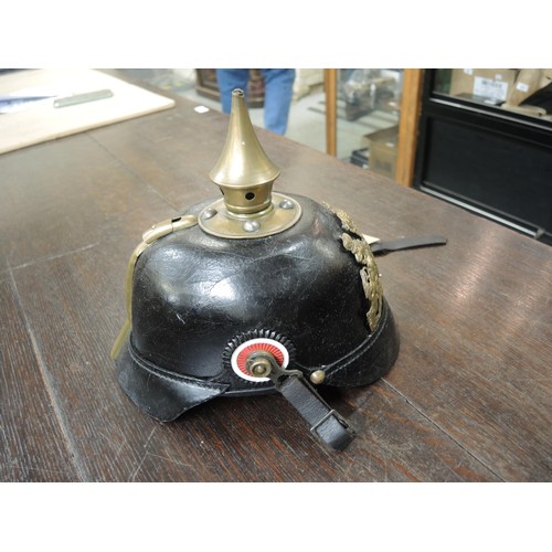 220 - Early 20th Century Bavarian pickelhaube, leather bound with brass fittings and leather liner