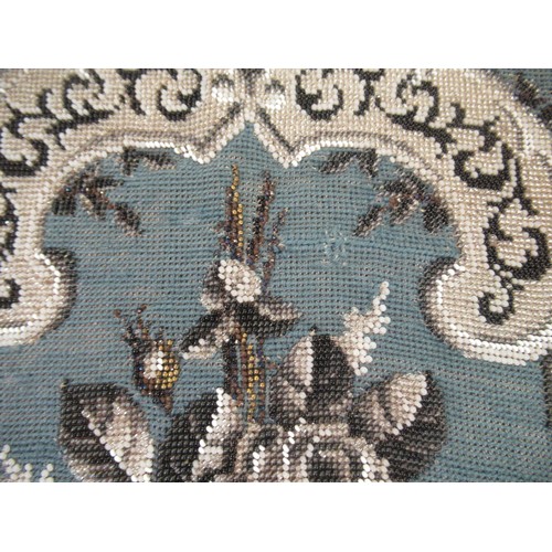 29 - Needlepoint and beadwork panel, stylised floral design of shield form on a blue ground, 45 x 39cm ap... 