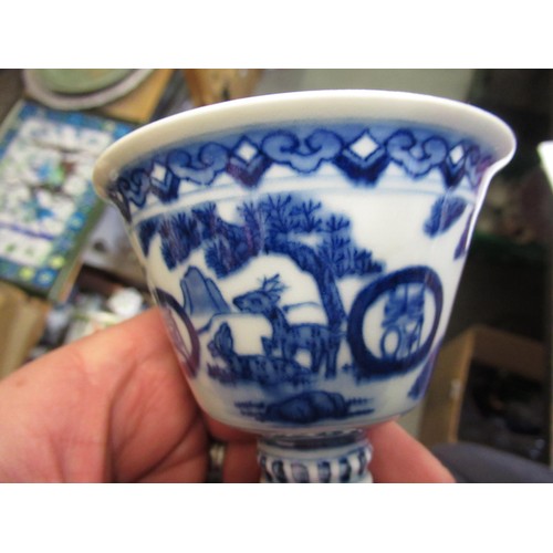 586 - Two Chinese blue and white stem cups, having character marks to bases, 10cm high