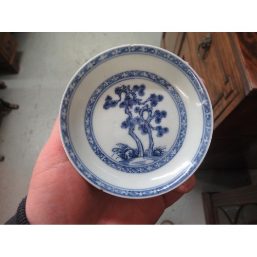 605 - Nanking Cargo blue and white tea bowl and saucer, the saucer 10cm diameter on a hardwood stand