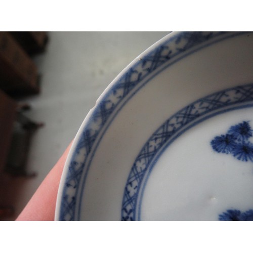 605 - Nanking Cargo blue and white tea bowl and saucer, the saucer 10cm diameter on a hardwood stand