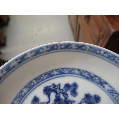 605 - Nanking Cargo blue and white tea bowl and saucer, the saucer 10cm diameter on a hardwood stand