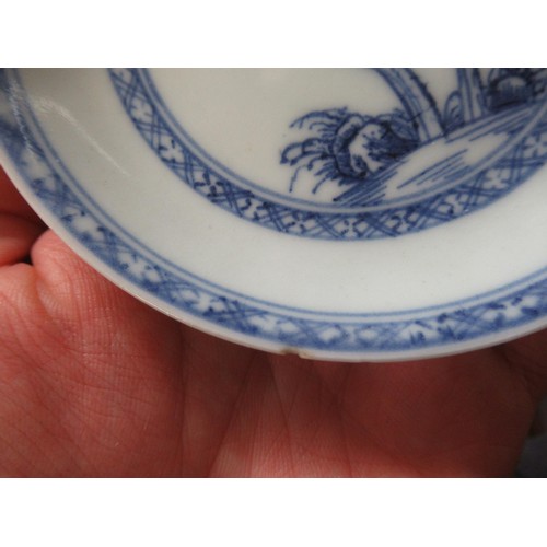 605 - Nanking Cargo blue and white tea bowl and saucer, the saucer 10cm diameter on a hardwood stand