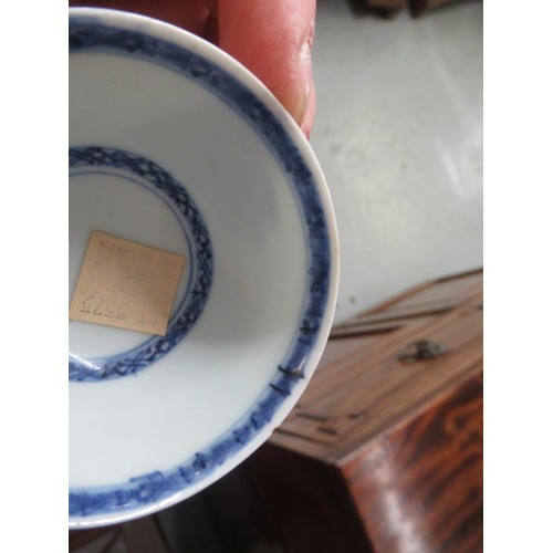 605 - Nanking Cargo blue and white tea bowl and saucer, the saucer 10cm diameter on a hardwood stand