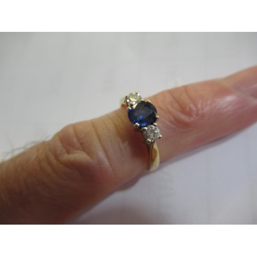 956 - 18ct Yellow gold ring set sapphire flanked by two diamonds, size K, 2.8g