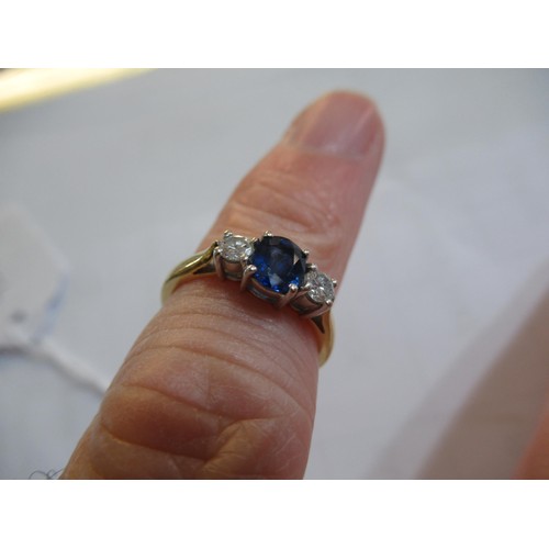 956 - 18ct Yellow gold ring set sapphire flanked by two diamonds, size K, 2.8g