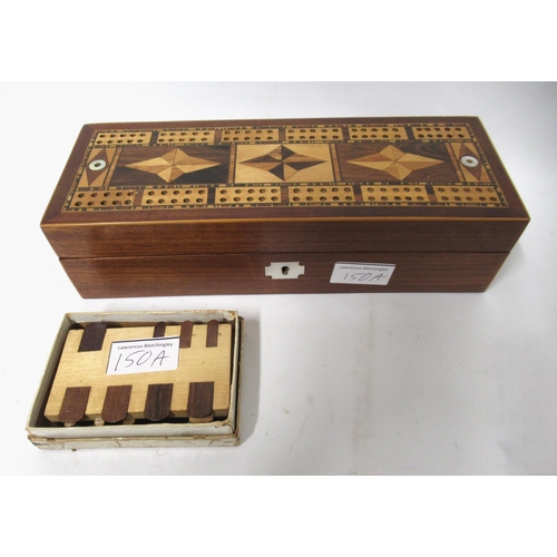 150A - Mahogany satinwood inlaid cribbage board together with a box of wooden whist markers