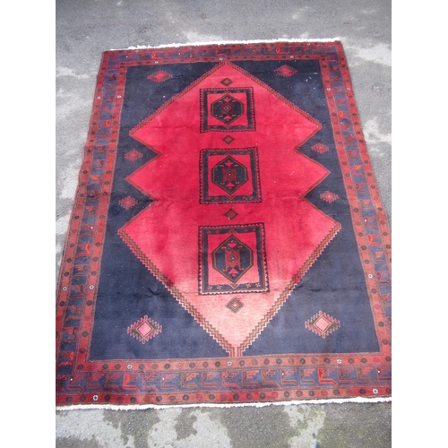 17 - Modern Belouch carpet with triple medallion design on a dark ground with borders (some moth damage)