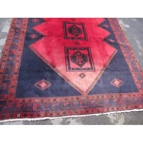 17 - Modern Belouch carpet with triple medallion design on a dark ground with borders (some moth damage)