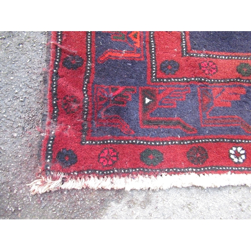 17 - Modern Belouch carpet with triple medallion design on a dark ground with borders (some moth damage)