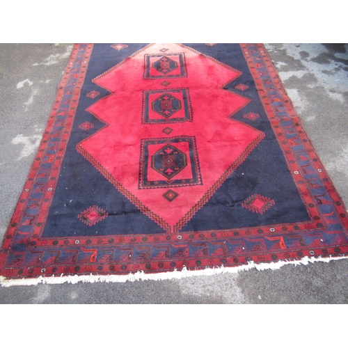 17 - Modern Belouch carpet with triple medallion design on a dark ground with borders (some moth damage)