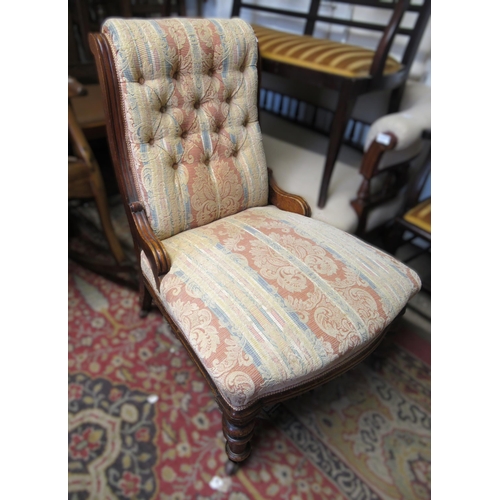 1960 - 19th Century walnut button upholstered low seat nursing chair, on turned supports with casters