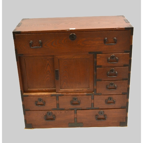 1962 - Japanese elm side cabinet, having iron mounts and handles, with arrangement of various drawers and s... 