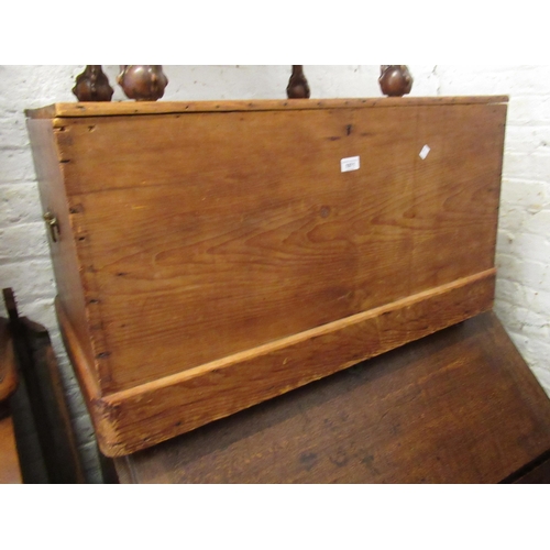 1971 - Stripped polished pine trunk, the hinged cover enclosing a candle box, raised on casters, 90cm wide ... 