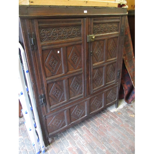 1974 - Oak two door cupboard, constructed from 17th Century panelling, with carved decoration, stile end su... 