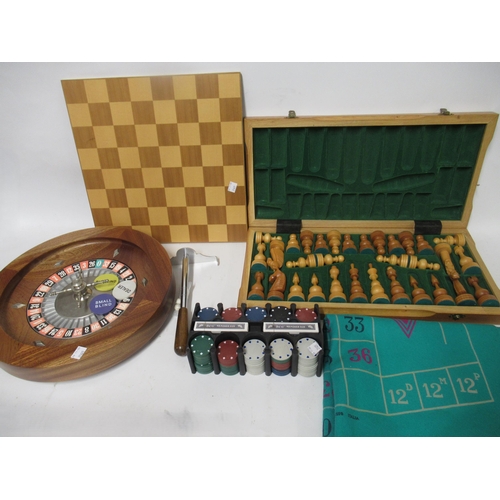 208 - Folding chess board with chess pieces, a roulette wheel, gaming counters and sundries