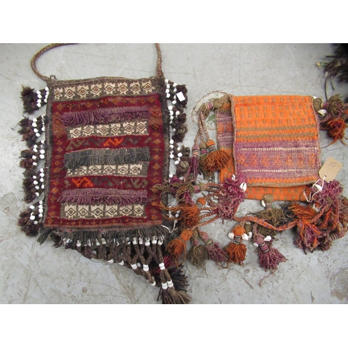 23 - Large flat weave saddlebag with tassels, together with two similar smaller bags mounted with beads a... 