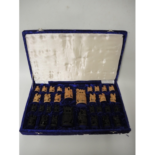 281 - 20th Century Indian carved natural and dark stained hardwood chess set in a fitted case