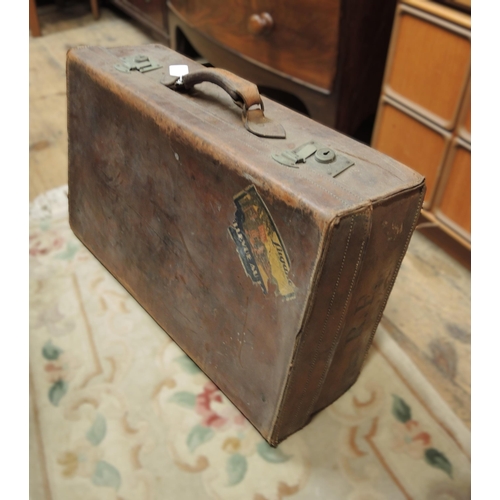 321 - Early 20th Century brown leather suitcase with various luggage labels