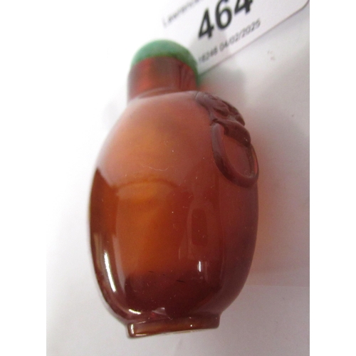 464 - Chinese amber snuff bottle, with lion mask handles and a jade stopper, 53mm high including stopper