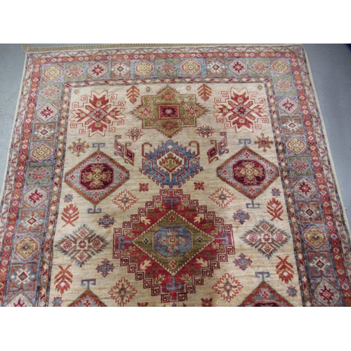 5 - Indo Persian rug of Caucasian design with multiple geometric motifs on a beige ground with borders, ... 