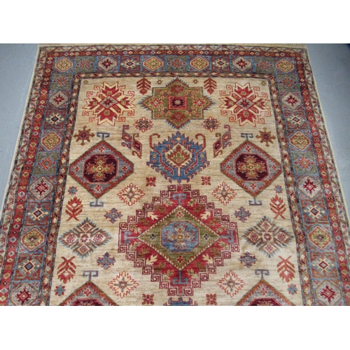 5 - Indo Persian rug of Caucasian design with multiple geometric motifs on a beige ground with borders, ... 