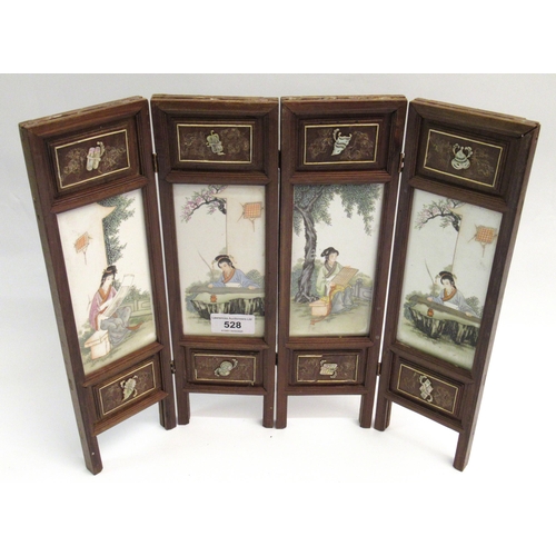 528 - Modern Chinese miniature wooden framed four fold screen having porcelain panels, decorated with figu... 