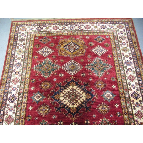 6 - Indo Persian rug of Caucasian design with multiple floral and hooked medallions on a red ground with... 