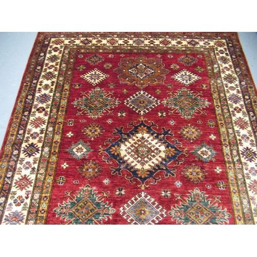 6 - Indo Persian rug of Caucasian design with multiple floral and hooked medallions on a red ground with... 