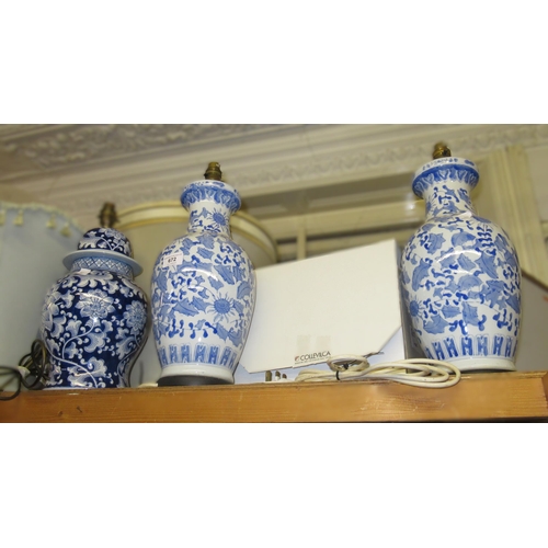 672 - Pair of modern Chinese blue and white baluster form table lamps, 37cms high together with another si... 