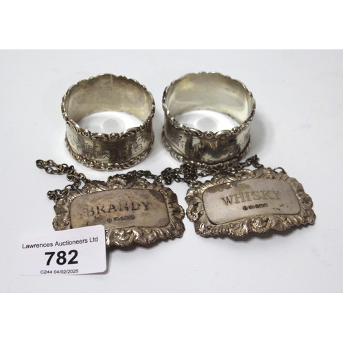 782 - Pair of Chester silver napkin rings 1907, and a silver whisky and brandy decanter label