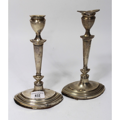 832 - Pair of Sheffield silver candlesticks (at fault)