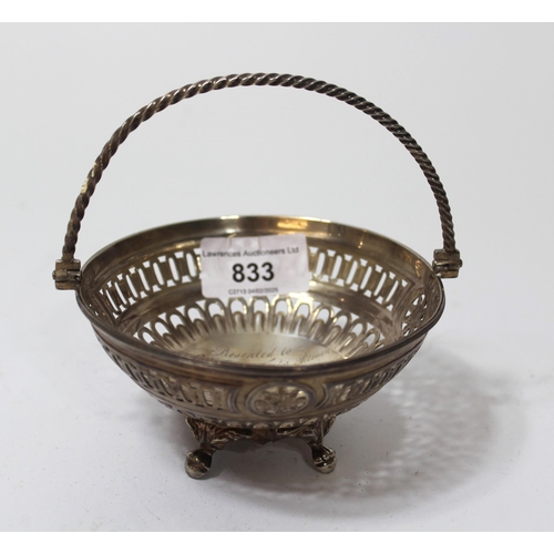 833 - George III silver dish having pierced embossed decoration with swing handle on shaped supports, 4.5o... 