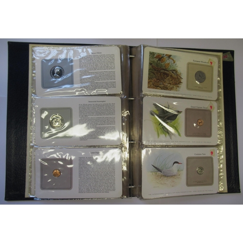 889 - Album containing a collection of Bird Coins of the World