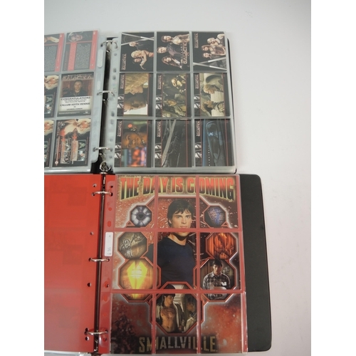 386 - One album of Inkworks Smallville trading cards including various autographs, an album of Battlestar ... 