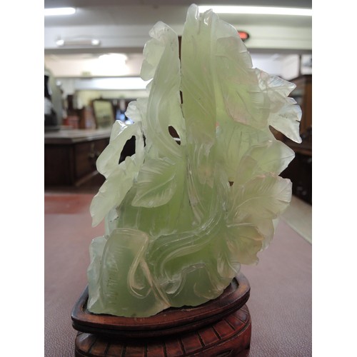 478 - Large 20th Century Chinese jadeite carving on a hardwood stand, 25cm high