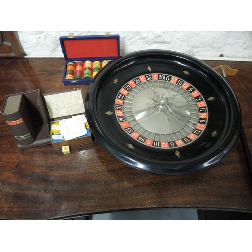 100C - 20th Century roulette wheel and croupier's stick, together with baize and gaming counters