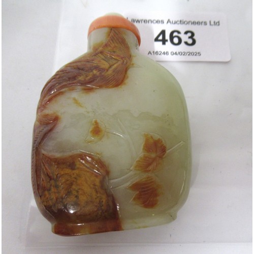 463 - Chinese pale green and russet jade snuff bottle, relief carved with a bird in foliage, with a coral ... 