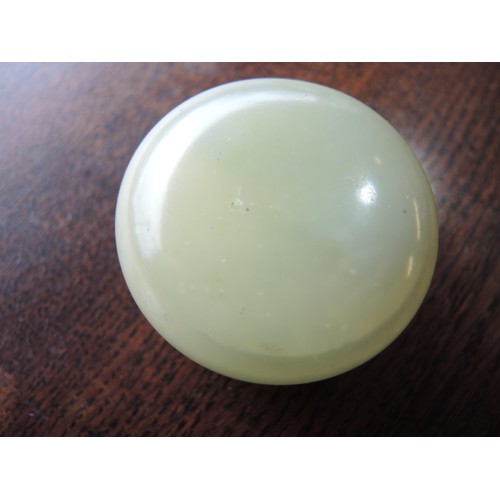 465 - Small circular pale green jade box and cover, 52mm diameter