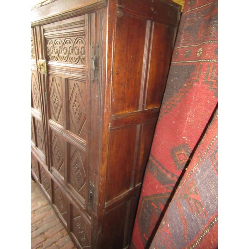 1974 - Oak two door cupboard, constructed from 17th Century panelling, with carved decoration, stile end su... 