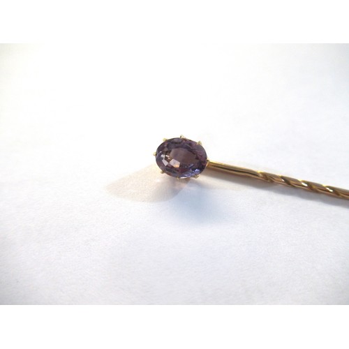 998 - 19th Century gold stick pin, mounted with an oval mauve sapphire