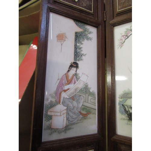 528 - Modern Chinese miniature wooden framed four fold screen having porcelain panels, decorated with figu... 