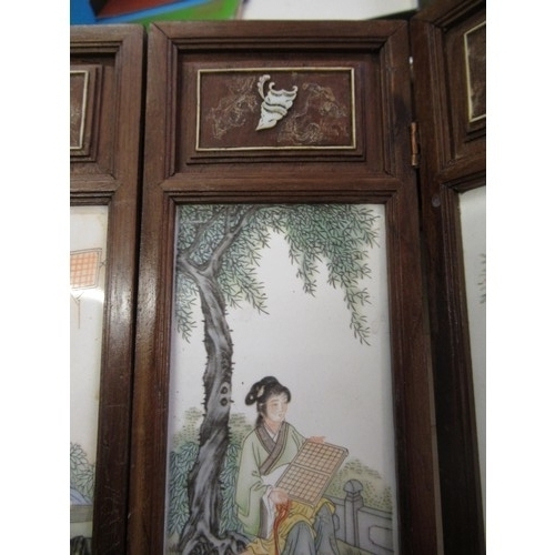 528 - Modern Chinese miniature wooden framed four fold screen having porcelain panels, decorated with figu... 