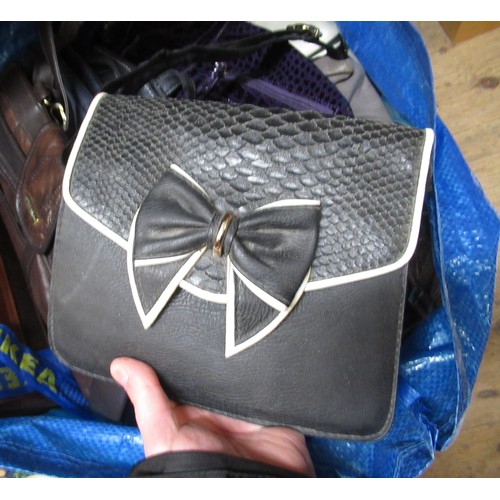 34 - Two bags containing a large collection of various ladies handbags, evening purses etc