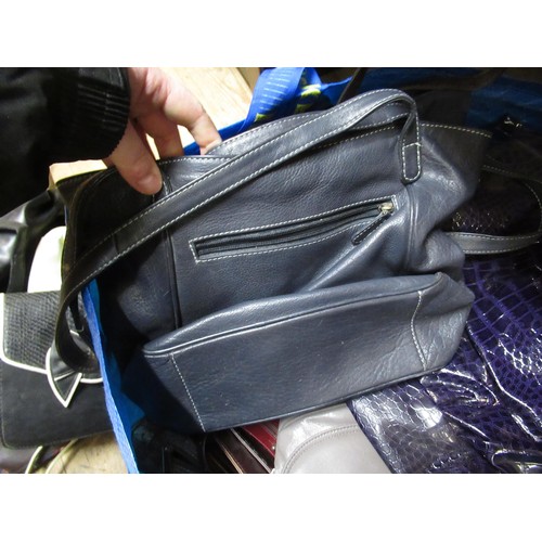 34 - Two bags containing a large collection of various ladies handbags, evening purses etc