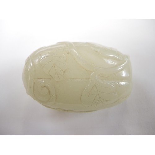 460 - Chinese pale green jade snuff bottle, with floral relief carved decoration and a dark green jade sto... 