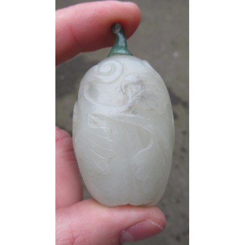 460 - Chinese pale green jade snuff bottle, with floral relief carved decoration and a dark green jade sto... 