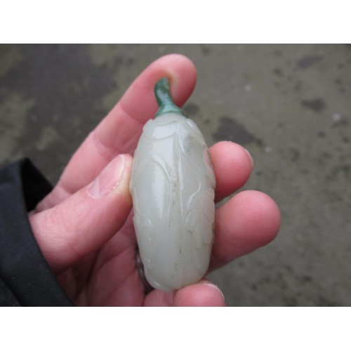 460 - Chinese pale green jade snuff bottle, with floral relief carved decoration and a dark green jade sto... 