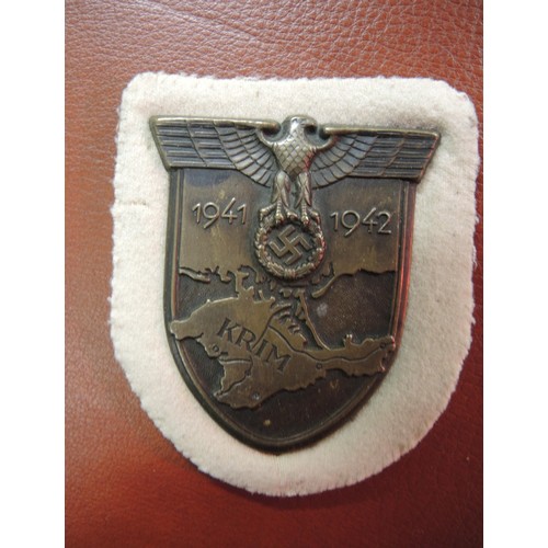 431 - World War II Third Reich Krim shield award, admin officer's tropical helmet eagle, and paratrooper i... 